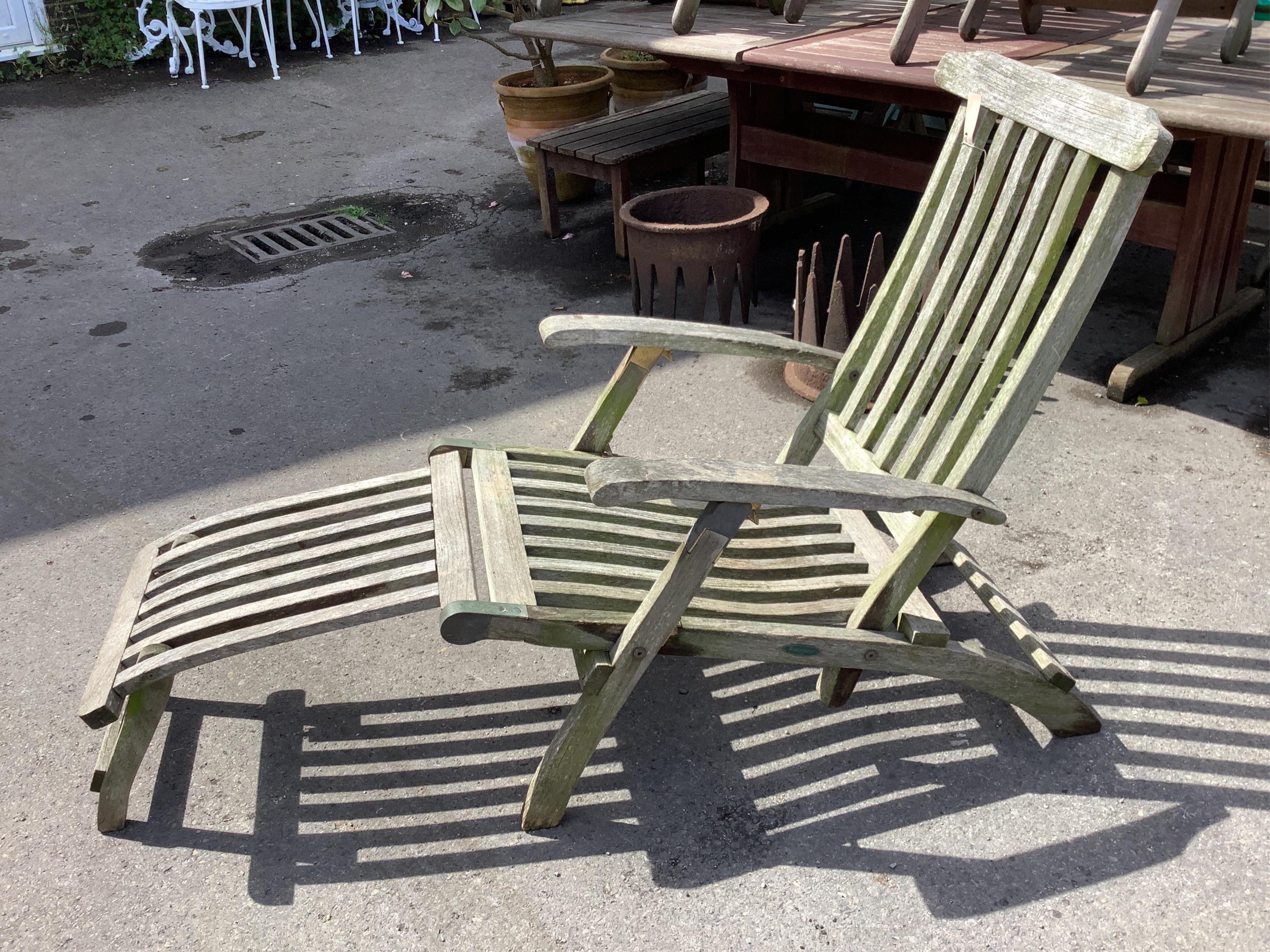 A brass mounted weathered teak steamer garden chair